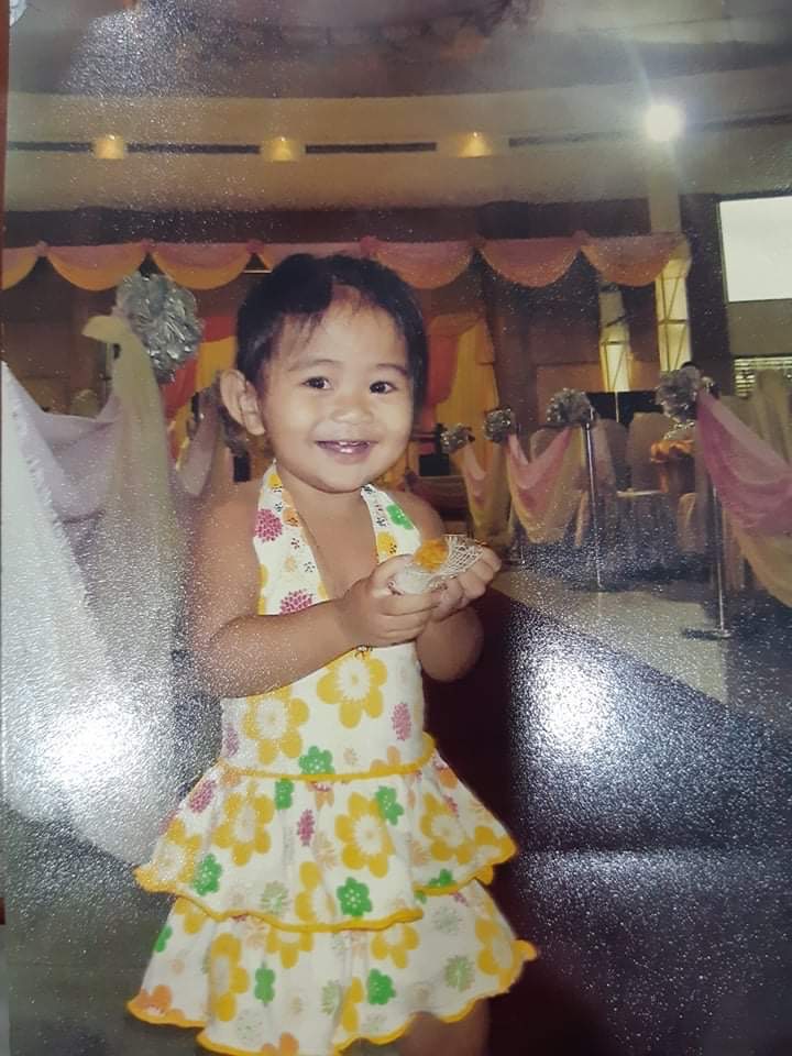 A baby picture of me holding a sweet treat!