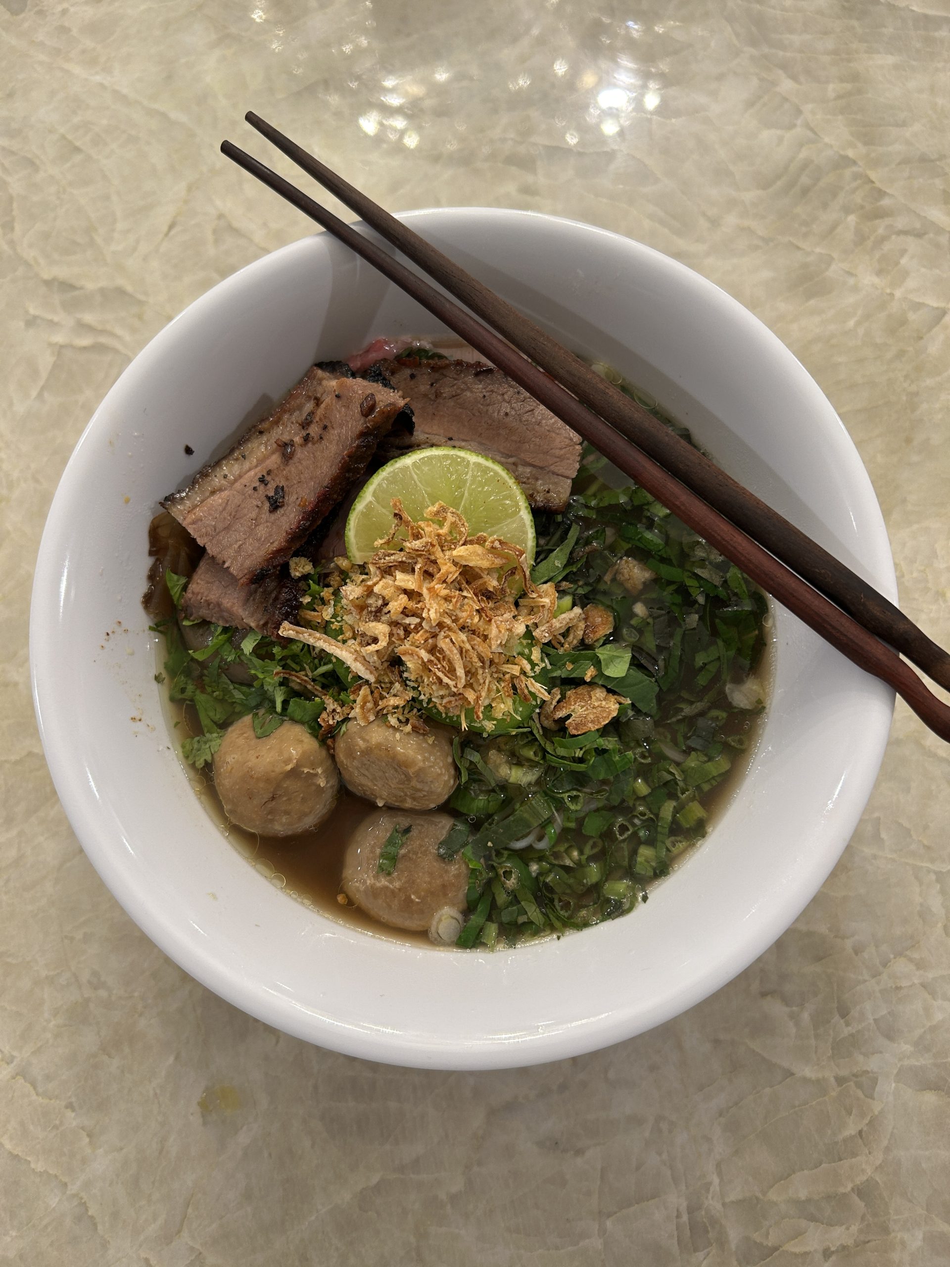 A picture of a soup called Pho in Laos style made by my friend's mom. 